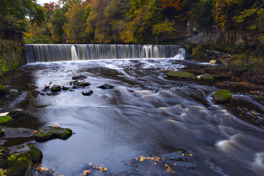 River Almond with waterfall at autumn time