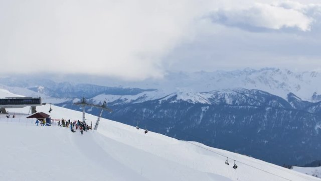 Group of people at ski resort on the peak of the mountain
