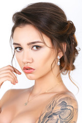 Beauty Fashion tattoo model with makeup and hair on a white background
