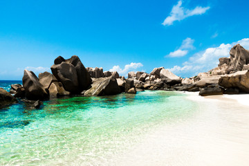 Natural pool on a tropical beach with huge rocks , Anse Marron, La digue, Seychelles
