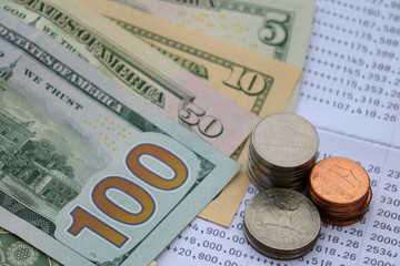 U.S. dollar banknote and coin on bank statement, investment saving concept