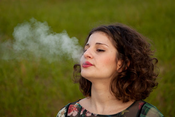 Casual young woman smoking a cigar