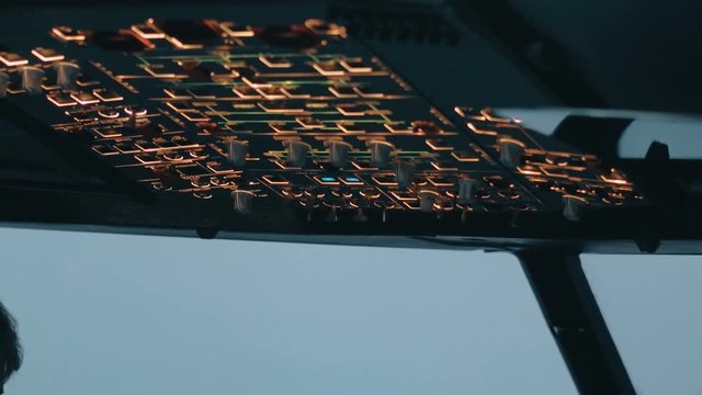 Close shot of overhead panel of modern aircraft. Aircraft commander switch switch control buttons and knobs. Inside shot of cockpit or cabin of Airbus A319 A320 A321
