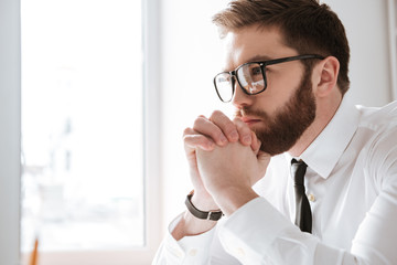 Serious young businessman looking at computer.