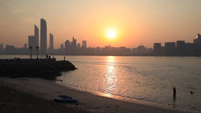 Sunrise with flying birds silhouettes in Abu Dhabi, United Arab Emirates 