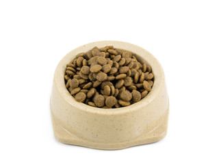 The close up of kibbles (dog food) in brown plastic dog bowl.