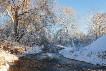 Winter park with snow trail and river at sun day