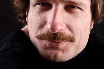 Close up portrait of a attractive man on black
