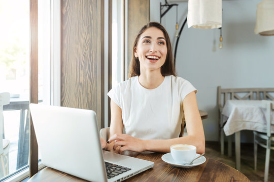 Laughing Beautiful Girl With Laptop In Restaurant