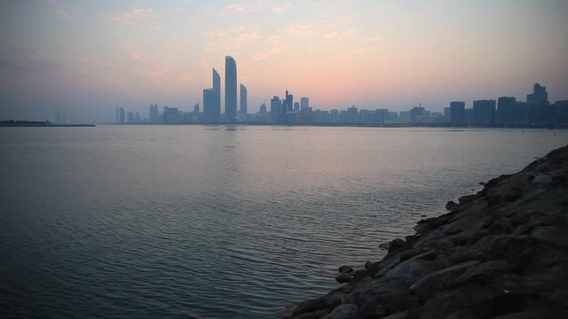 Abu Dhabi skyline at sunrise time. Establishing shot.