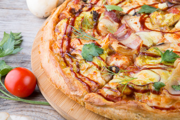 Whole baked pizza on wooden board