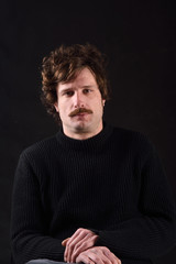 Portrait of an attractive man on black background