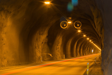 Tunnel with lights and trails of car traffic
