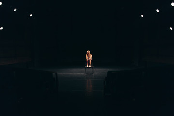 female actress alone on stage