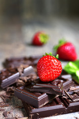 Stack of chocolate slices with fresh ripe strawberry.