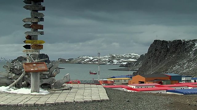 Frei station villa las estrellas,  sign with sea and boat in the background