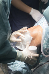 Obraz premium Knee surgery nurse bandaging