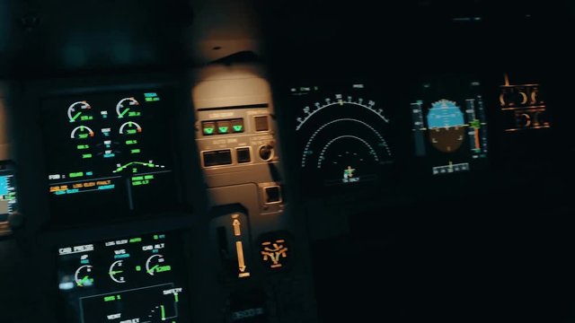 Close shot and panorama of aircraft cabin or cockpit with EFIS. Flight deck centre panel with primary flight display and navigation display, aircraft commander and co-pilot panels. Interior of Airbus