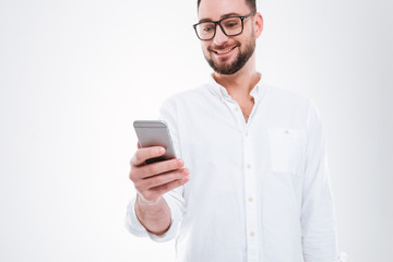 Handsome happy young bearded man chatting by phone