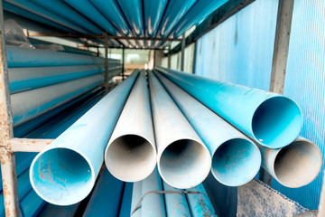 Stacks of PVC water pipes in warehouse, Selective focus