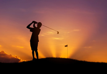 Fototapeta na wymiar silhouette the golfer hit golf ball toward the hole at sunset