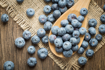 Blue berries on old wooden table.top view