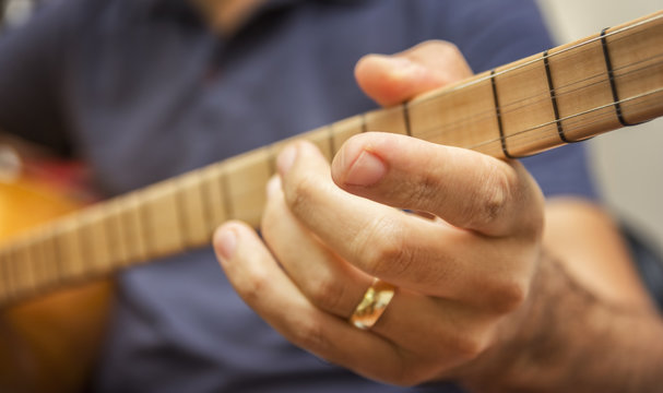 Closeup Shot Of A Man Playing Baglama (Turkish traditional stringed instrument) - Saz