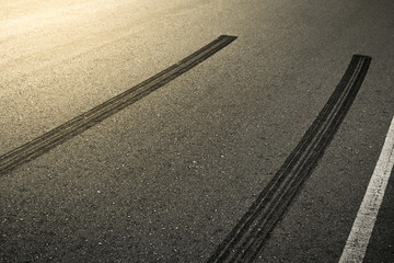Fototapeta premium Abstract asphalt road background with crossing of tires tracks