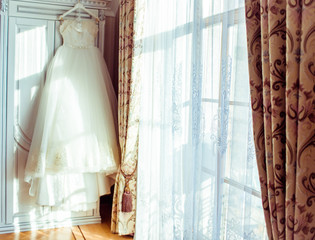 The wedding dress hang on the hanger