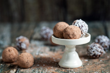 Truffle chocolate candies on cocoa powder and coconut
