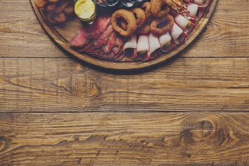 Seafood and meat platter on wooden table background