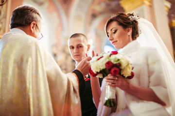 The charming bride stands in the church