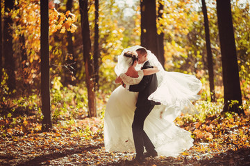 The lovely couple in love embracing in the forest
