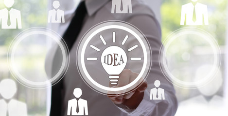 Business, technology concept - businesswoman pressing button with bulb on virtual screens. Ideas in business