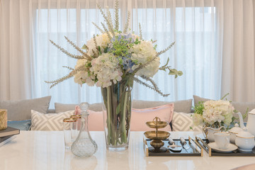 luxury table set on dinnig table with vase of flower in dining r
