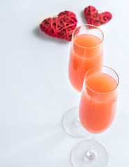 Two bellini cocktails with hearts