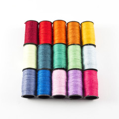 Sewing threads on white background