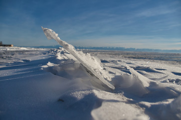 Snow-covered ice. In the background the mountains.