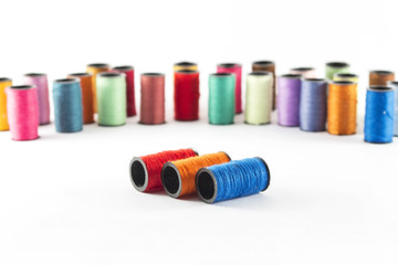 Sewing threads on white background