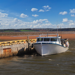 Lobster Boat tied up to a wharf in rural Prince Edward Island, Canada.