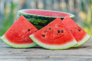 water melon slice on wood texture in nature background.
