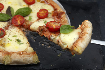 Hot true PEPPERONI ITALIAN PIZZA with salami and cheese. TOP VIEW Tasty traditional pepperoni pizza on board on wooden table with decoration