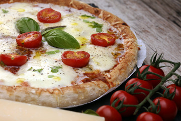 Hot true PEPPERONI ITALIAN PIZZA with salami and cheese. TOP VIEW Tasty traditional pepperoni pizza on board on wooden table with decoration