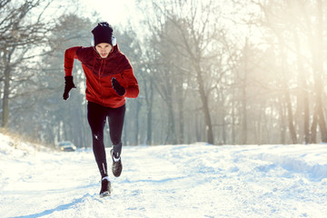 Sportsman Running in Extreme Snow Conditions. Intensive Training Outdoors.