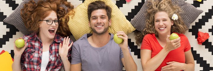 Cheerful friends with green apples