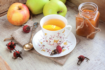 Tea with a lemon and apple jam selective focus