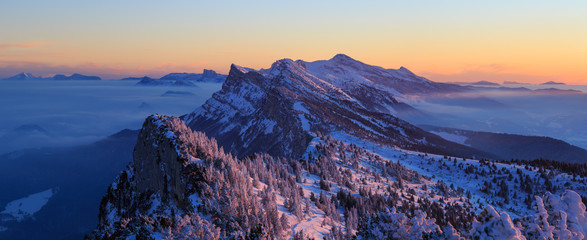 Snow covered mountainrange, Vercors, France, during a winter sunrise.