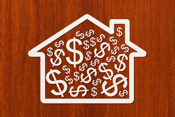 Paper house with dollars inside. Conceptual image