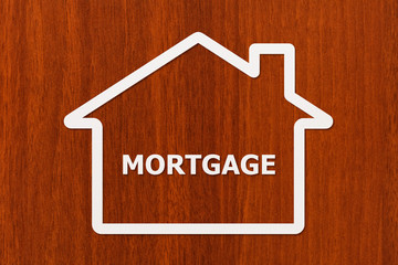 Paper house with mortgage word inside. Conceptual image
