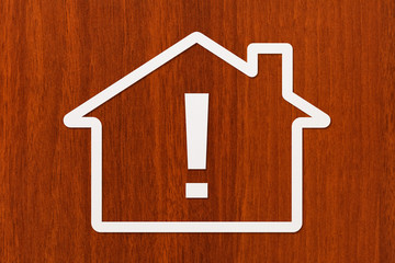 Paper house with exclamation point inside. Conceptual image